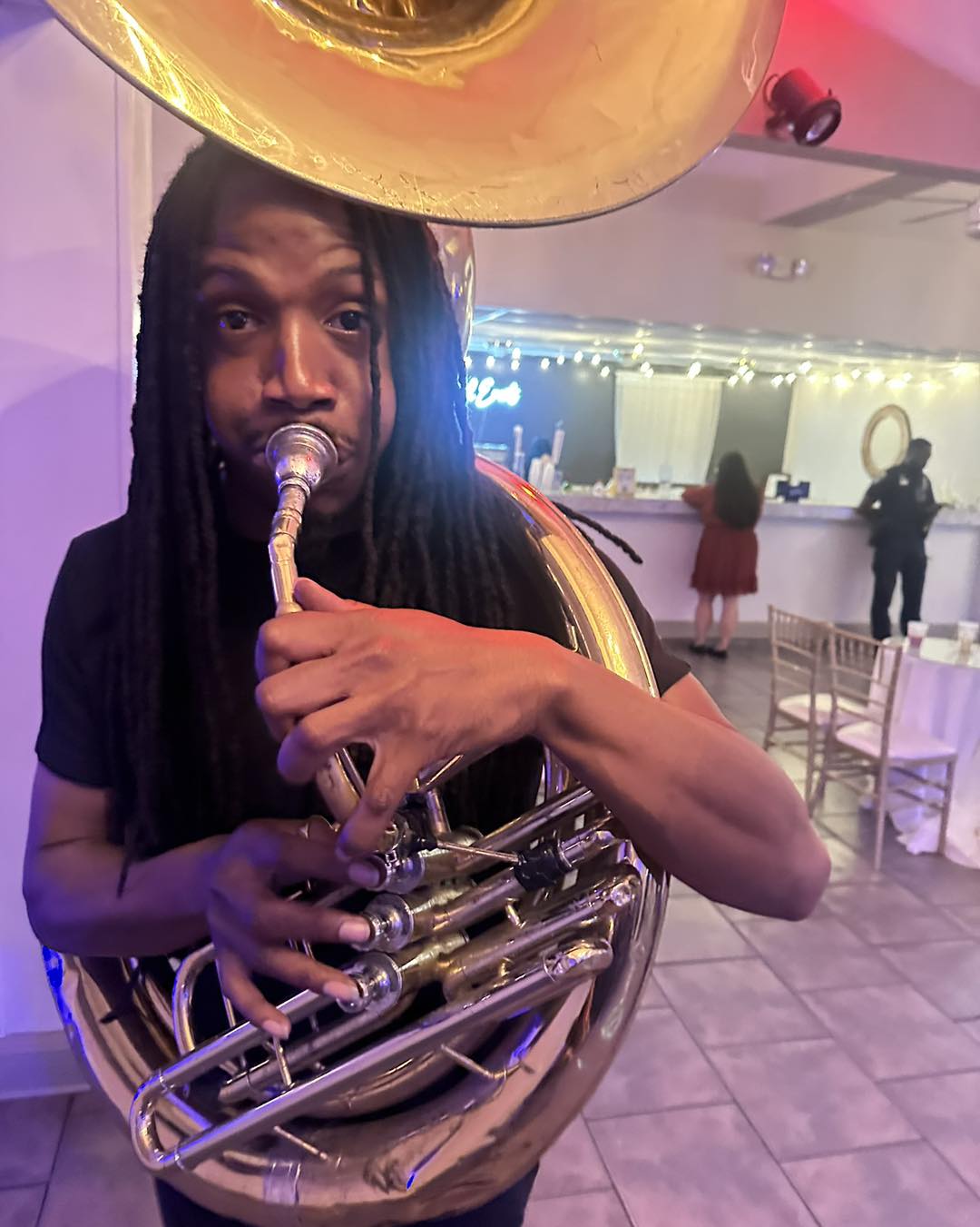 Sousaphone player performing up close at a celebration